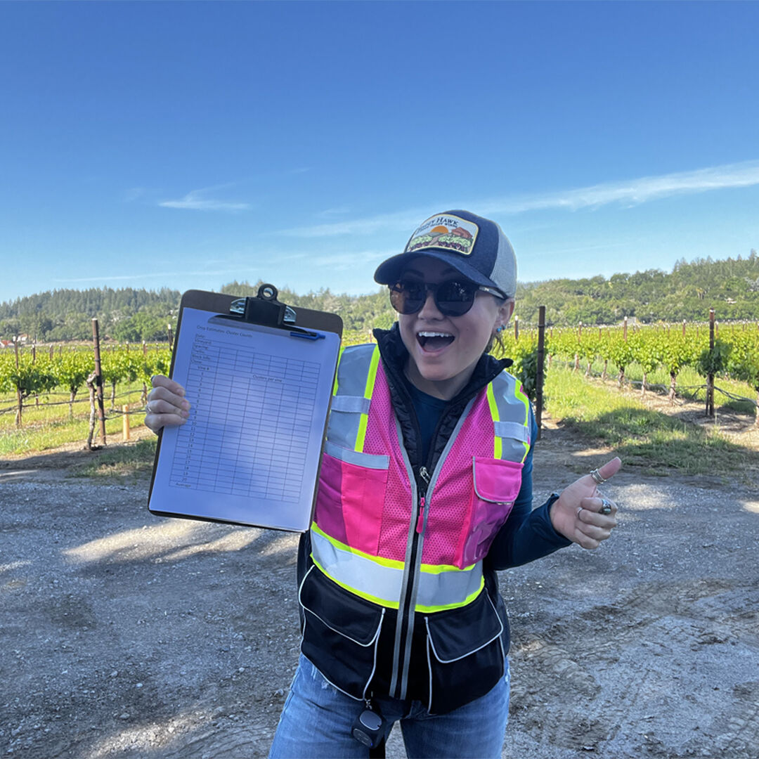Lauren in vineyard with clipboard